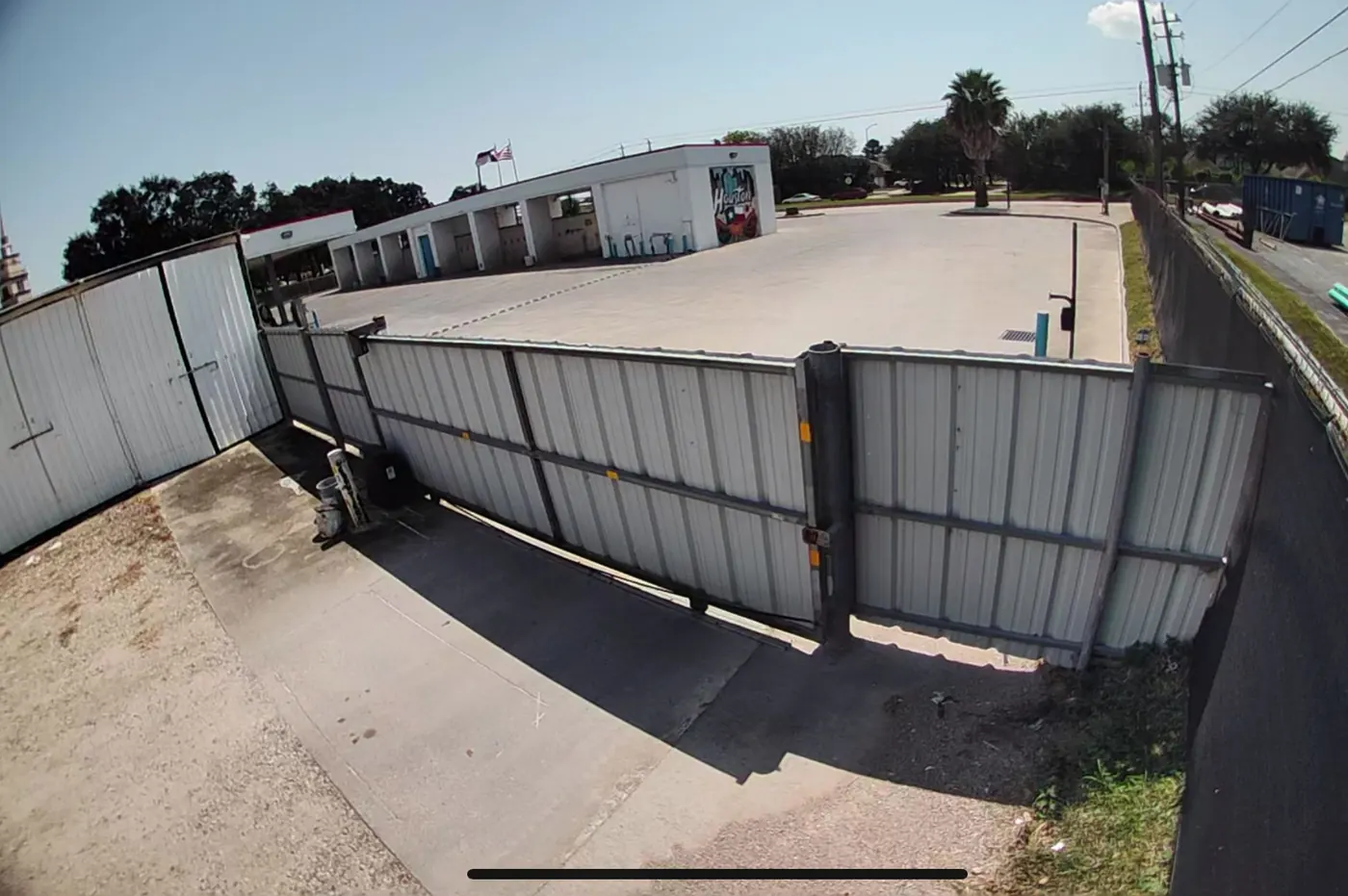 Fenced entry gate and paved drive at Almeda Genoa Storage